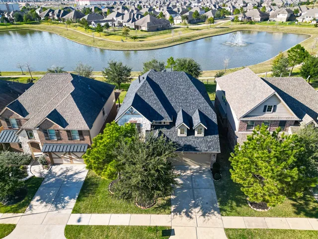 an aerial view of a house with a swimming pool