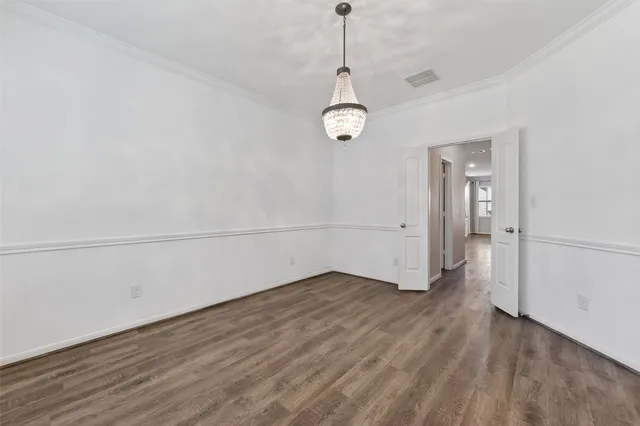 a view of a room with wooden floor and white walls