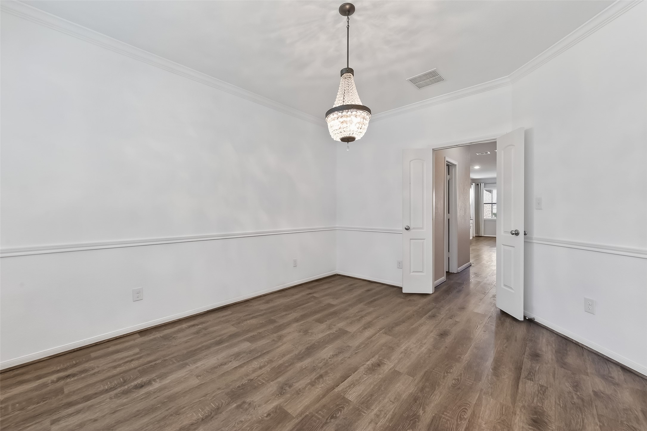 9151 Monarch Field Lane Cypress, TX 77433 - Photo 11 of 48 a view of a room with wooden floor and white walls