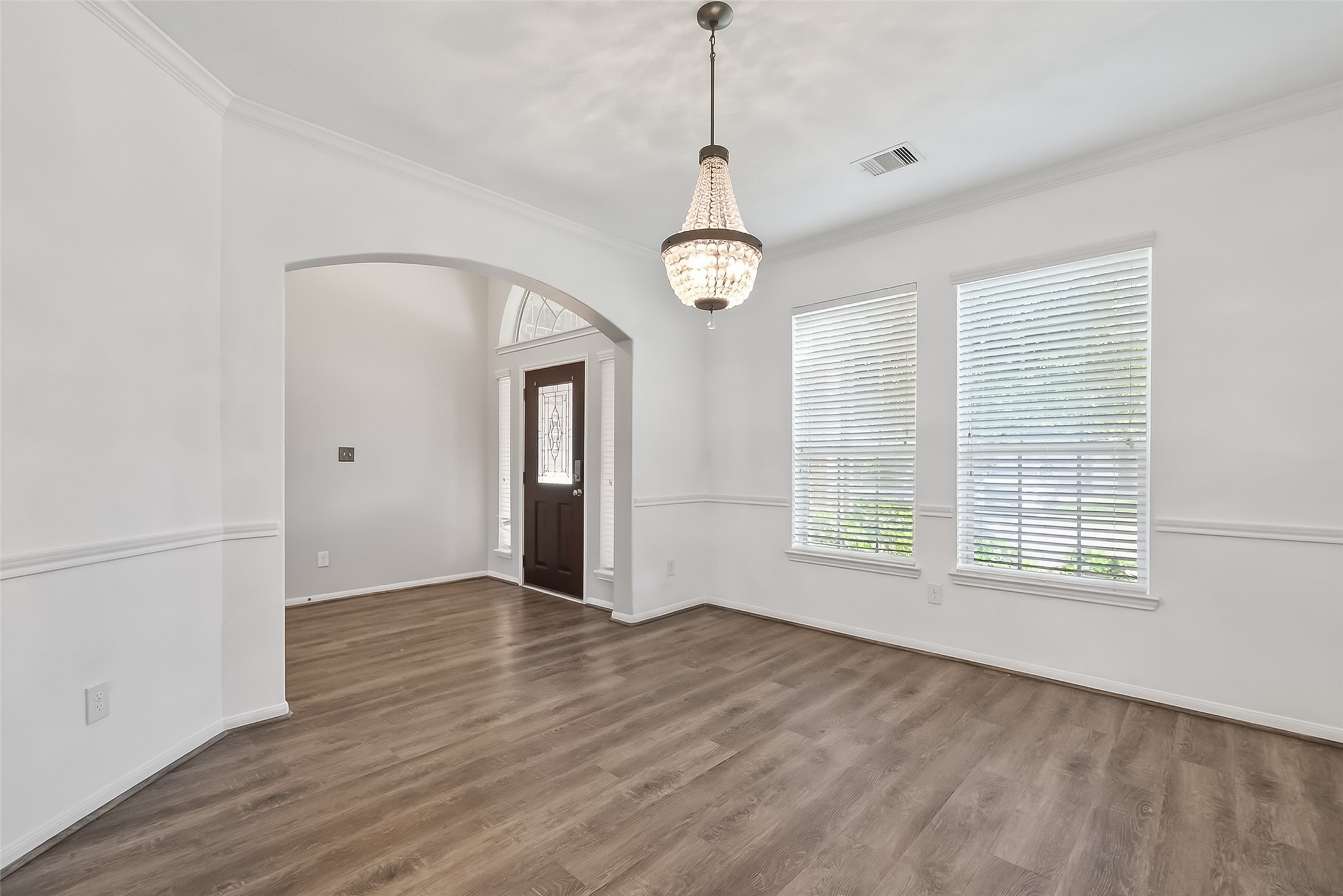 9151 Monarch Field Lane Cypress, TX 77433 - Photo 12 of 48 a view of an empty room with wooden floor and a window