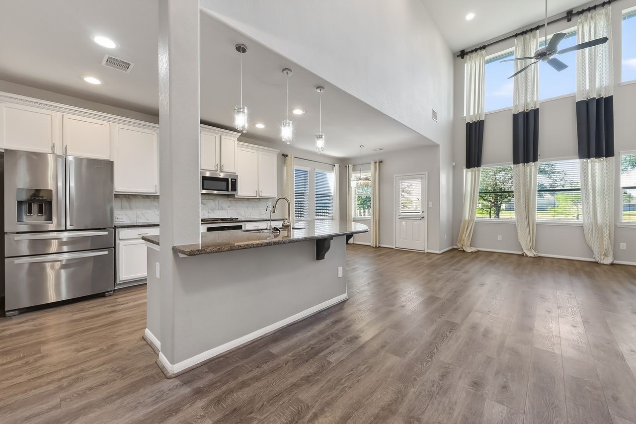 9151 Monarch Field Lane Cypress, TX 77433 - Photo 15 of 48 a kitchen with stainless steel appliances a refrigerator and a stove top oven