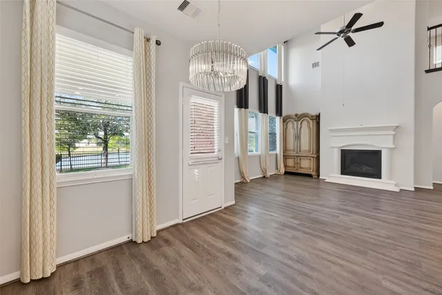 a view of a hallway with wooden floor and a fireplace