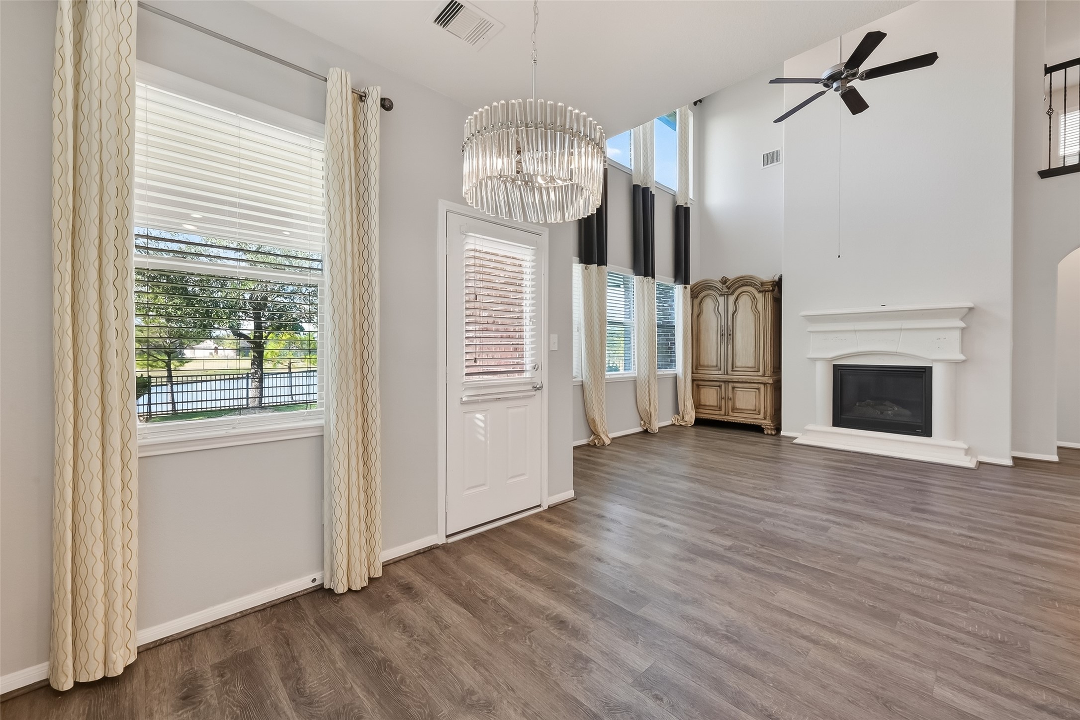 9151 Monarch Field Lane Cypress, TX 77433 - Photo 17 of 48 a view of a hallway with wooden floor and a fireplace