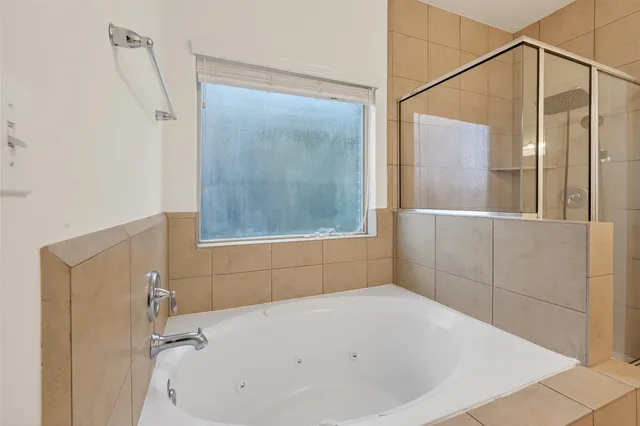 a bathroom with a bathtub and a shower