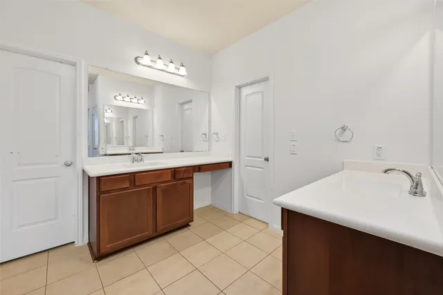 a spacious bathroom with a double vanity sink mirror and
