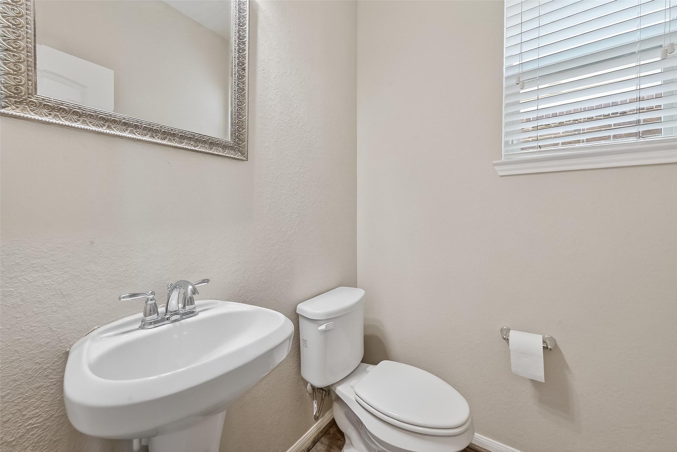 9151 Monarch Field Lane Cypress, TX 77433 - Photo 30 of 48 a white toilet sitting next to a white sink