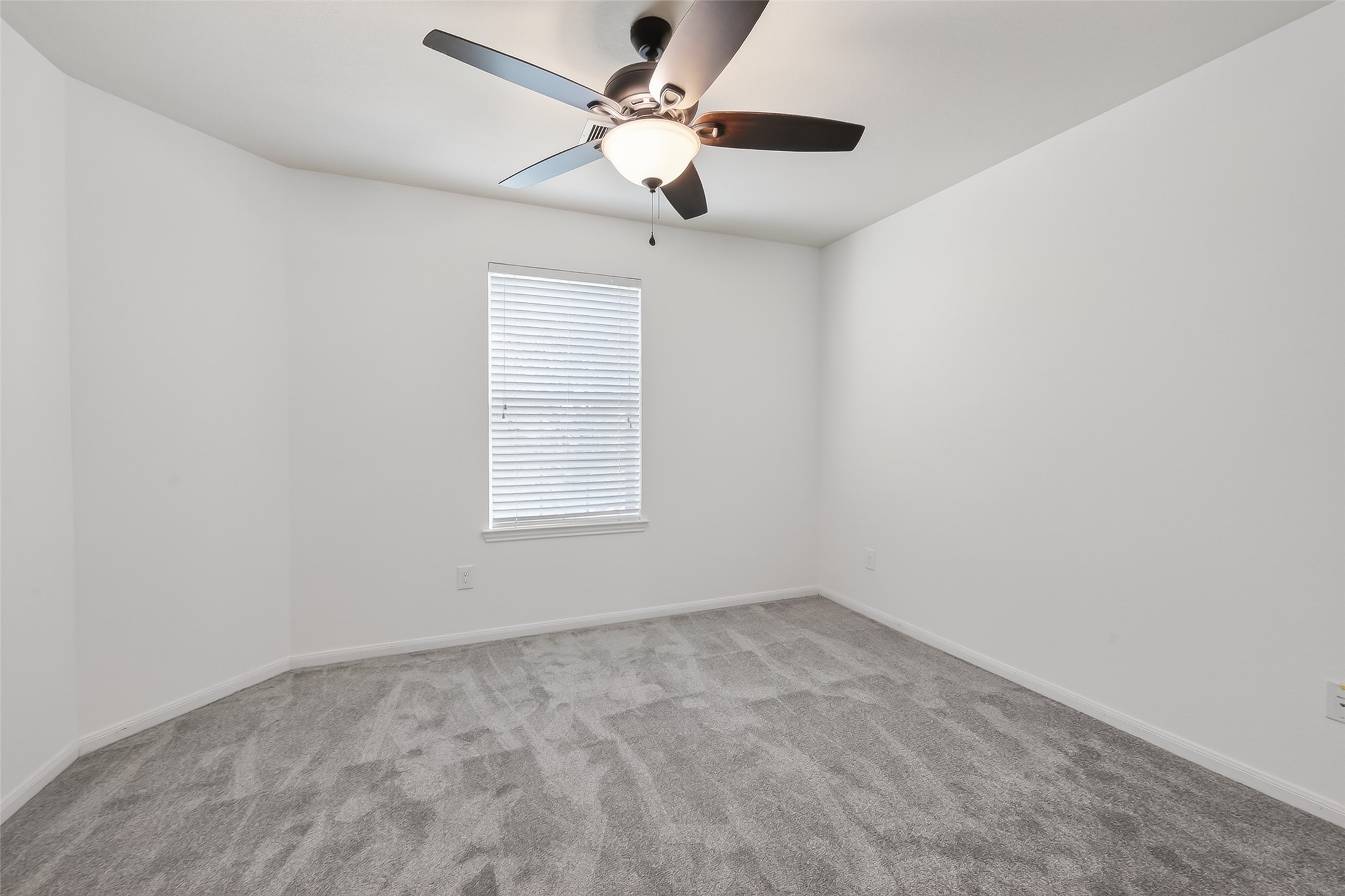 9151 Monarch Field Lane Cypress, TX 77433 - Photo 34 of 48 an empty room with a window and a fan