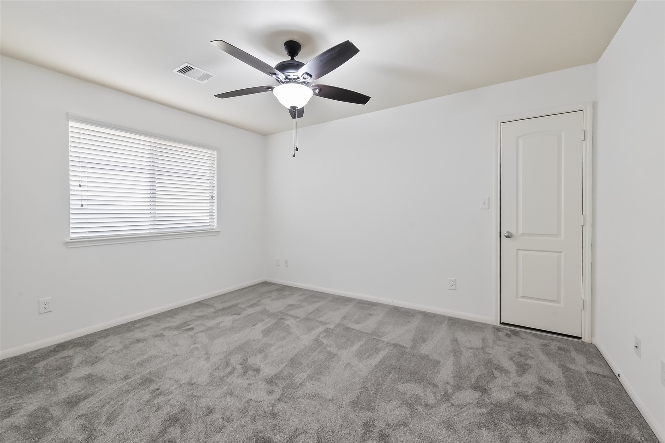 9151 Monarch Field Lane Cypress, TX 77433 - Photo 38 of 48 an empty room with a window and a fan