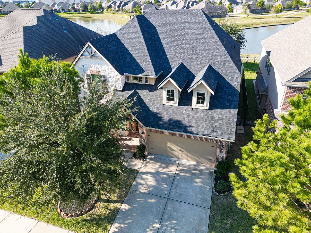 9151 Monarch Field Lane Cypress, TX 77433 - Photo 4 of 48 a front view of a house with a yard