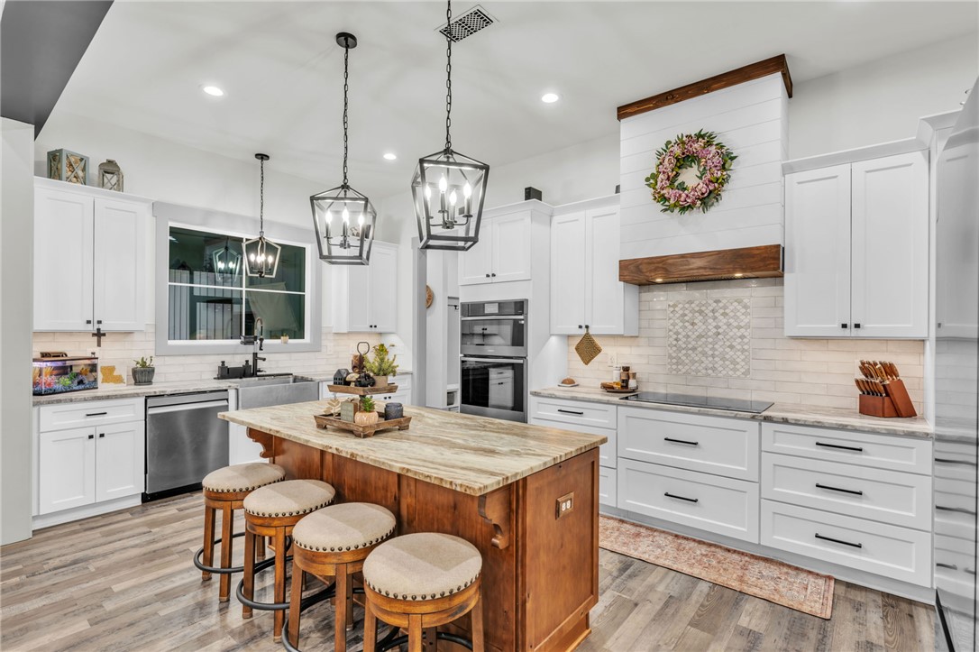919 Watercrest Road West Union, SC 29696 - Photo 11 of 50 This modern kitchen features a spacious island, white cabinetry, and contemporary fixtures throughout.