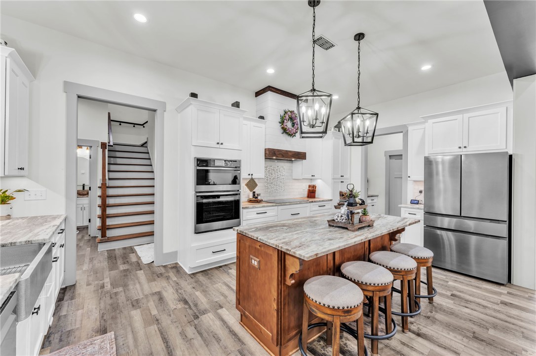 919 Watercrest Road West Union, SC 29696 - Photo 12 of 50 This bright kitchen features an island, stainless steel appliances, and sleek flooring, creating an inviting space.