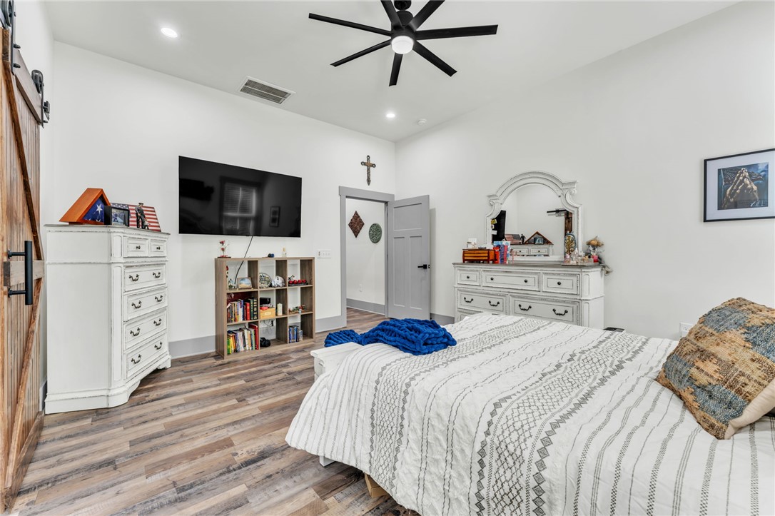 919 Watercrest Road West Union, SC 29696 - Photo 16 of 50 This spacious bedroom features wood flooring and a modern ceiling fan, creating a comfortable living space.