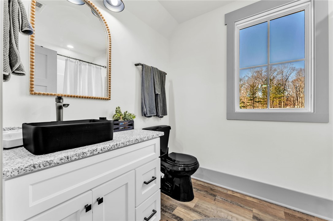919 Watercrest Road West Union, SC 29696 - Photo 21 of 50 This bathroom features a contemporary vanity with a sleek black sink and modern fixtures.