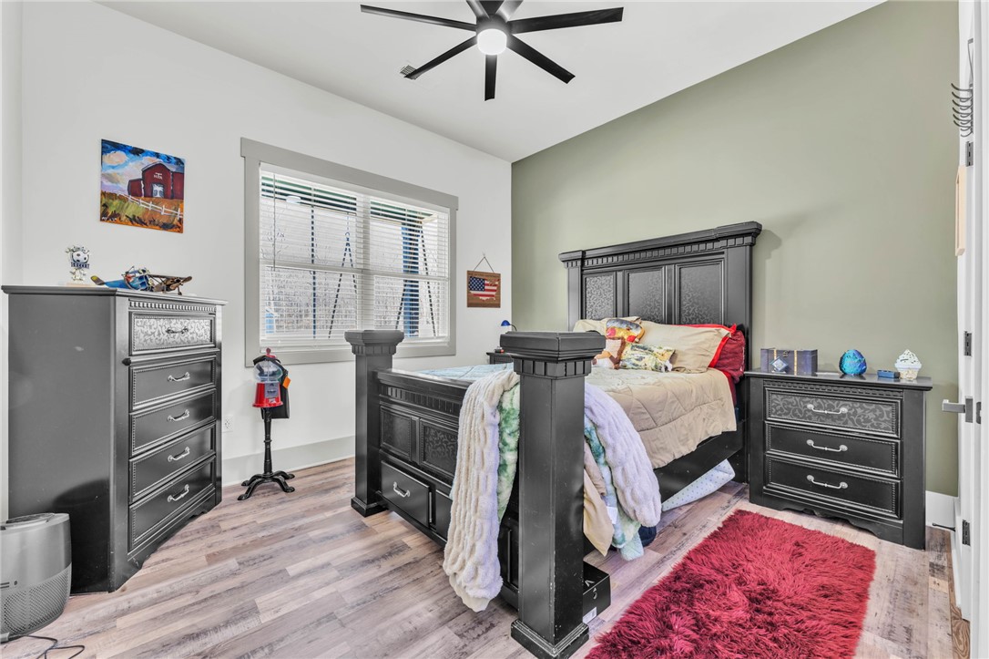 919 Watercrest Road West Union, SC 29696 - Photo 28 of 50 This cozy bedroom features durable flooring and a bright window, offering a comfortable personal retreat.