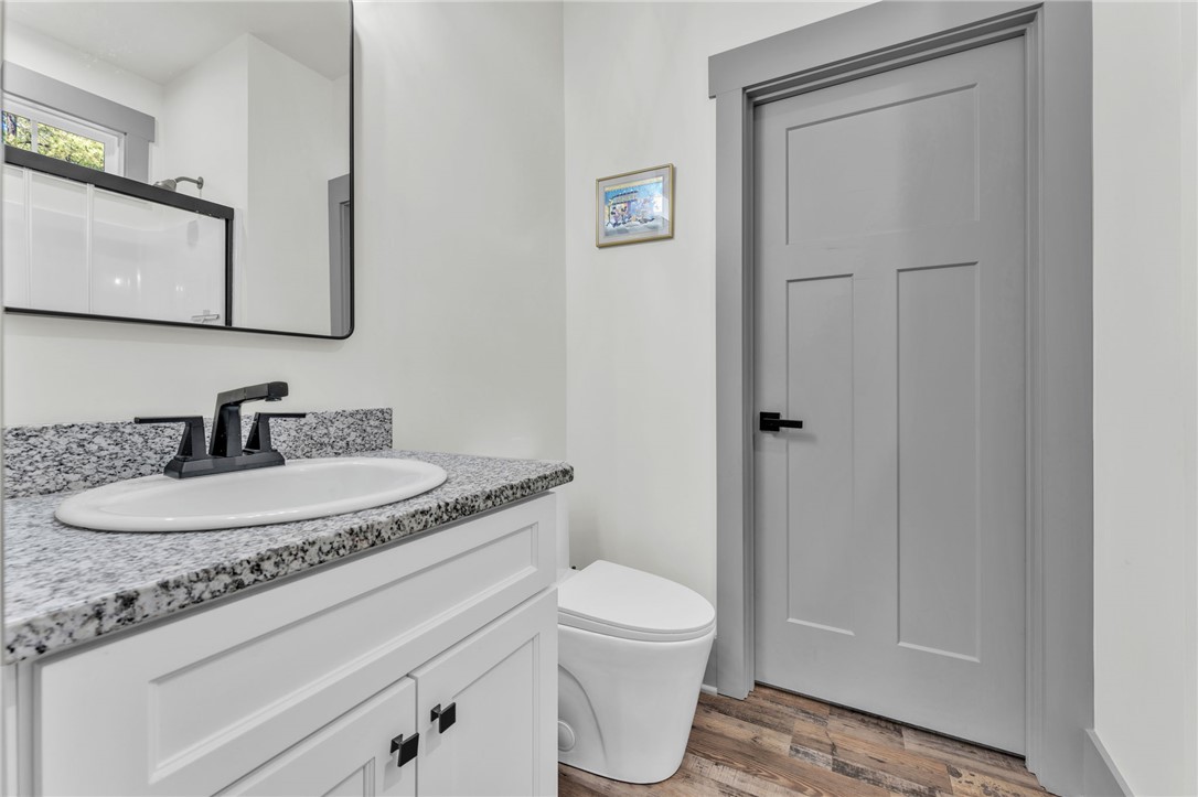 919 Watercrest Road West Union, SC 29696 - Photo 29 of 50 This bathroom features a contemporary vanity with a granite countertop and a sleek toilet.