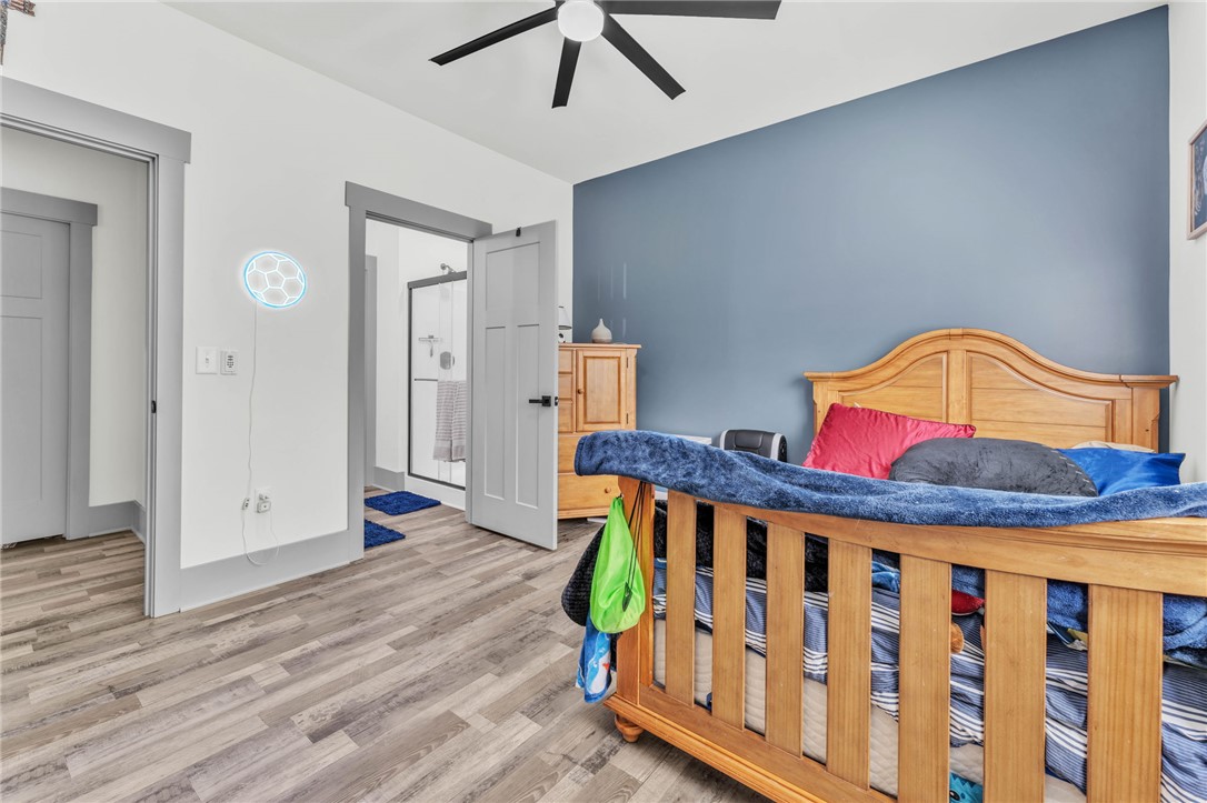 919 Watercrest Road West Union, SC 29696 - Photo 30 of 50 This spacious bedroom features wood flooring, a ceiling fan, and an en-suite bathroom.