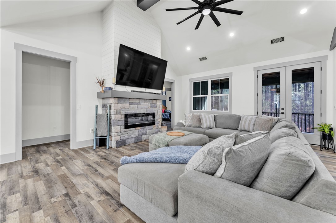919 Watercrest Road West Union, SC 29696 - Photo 6 of 50 This inviting living area boasts vaulted ceilings and a stone fireplace, perfect for gatherings.