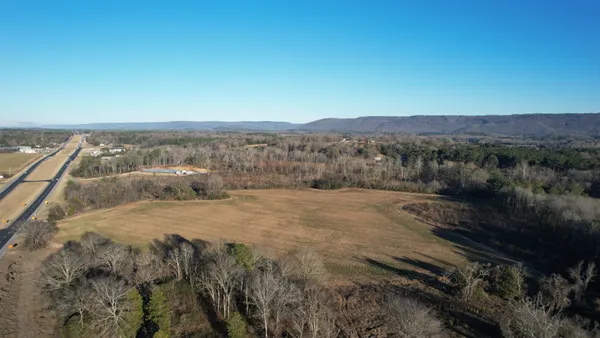 a view of a dry yard with wooden floor and mountain view
