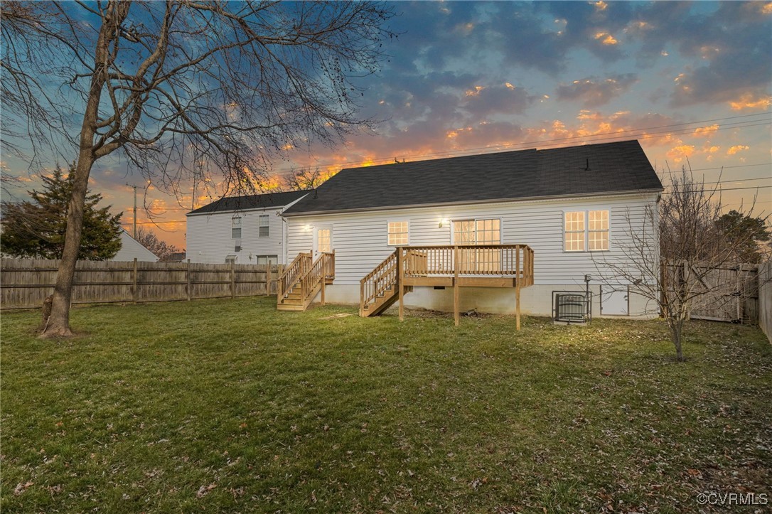 5847 Warwick Road Richmond, VA 23225 - Photo 1 of 1 Back house at dusk with a deck and a yard