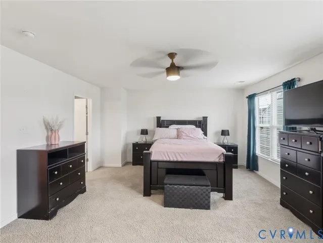 a spacious bedroom with a bed and furniture