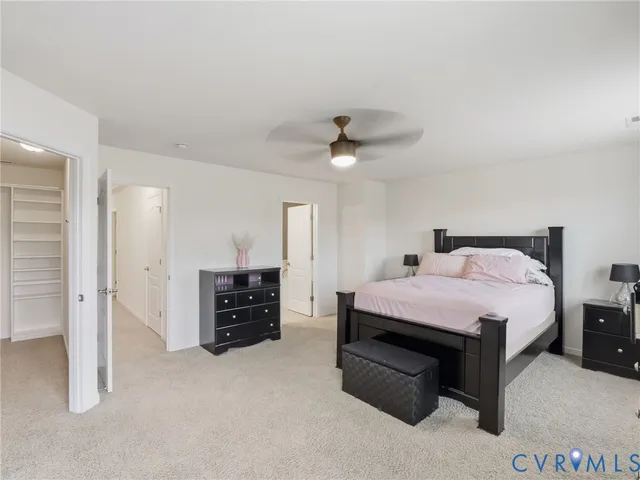 a large bedroom with a bed and a dresser