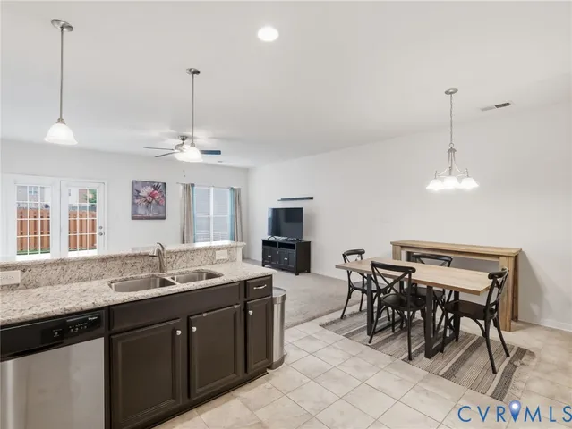 a kitchen with granite countertop a refrigerator sink and microwave