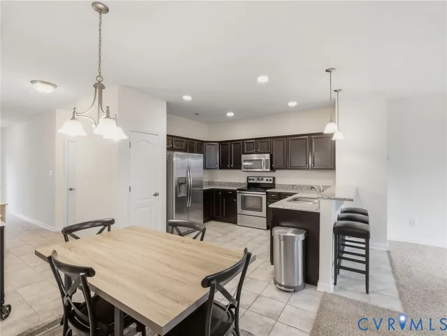 a view of a dining room with furniture and chandelier