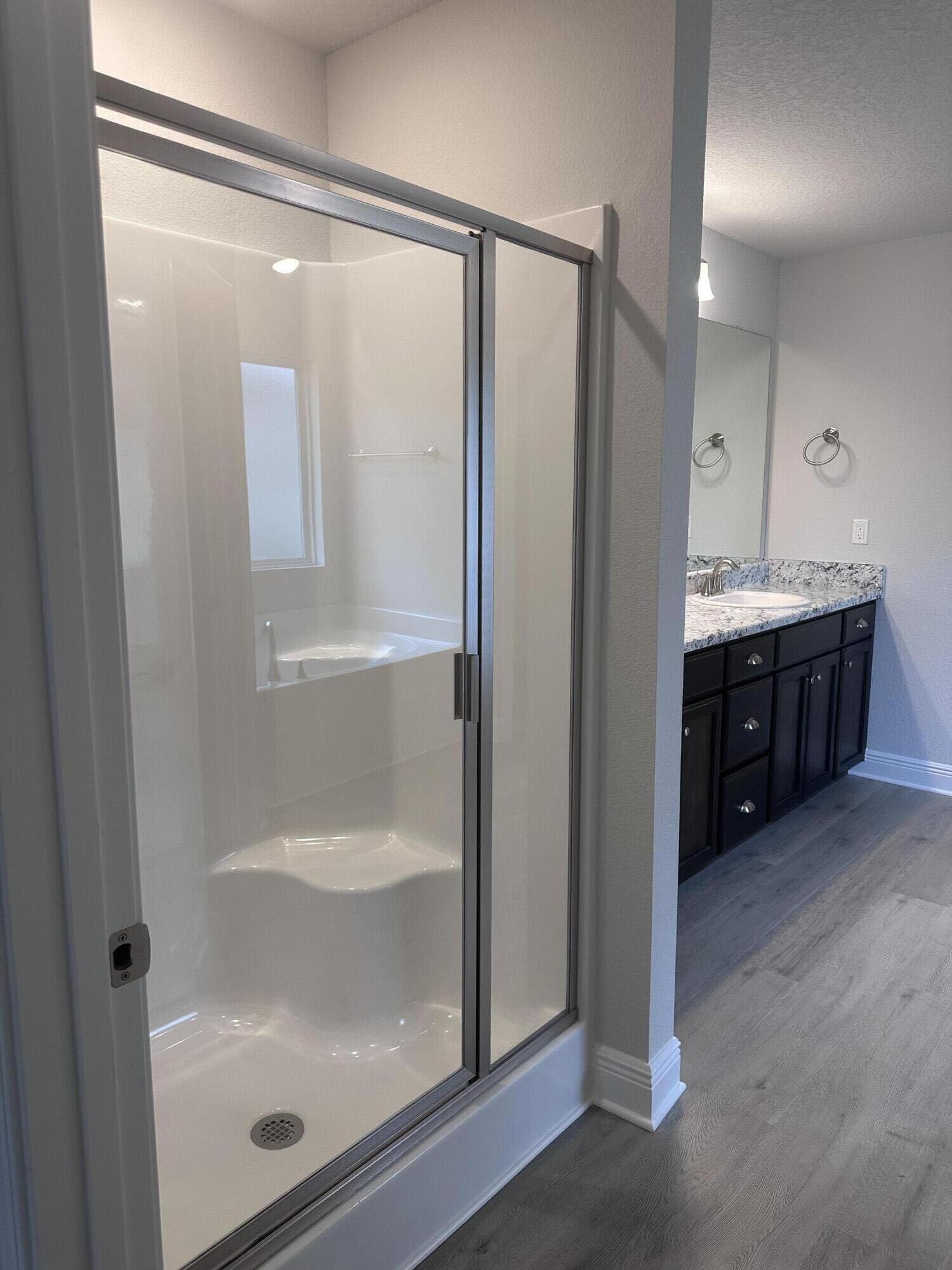 6115 Buckshot Drive Crestview, FL 32539 - Photo 19 of 29 a bathroom with a glass door shower a sink and mirror