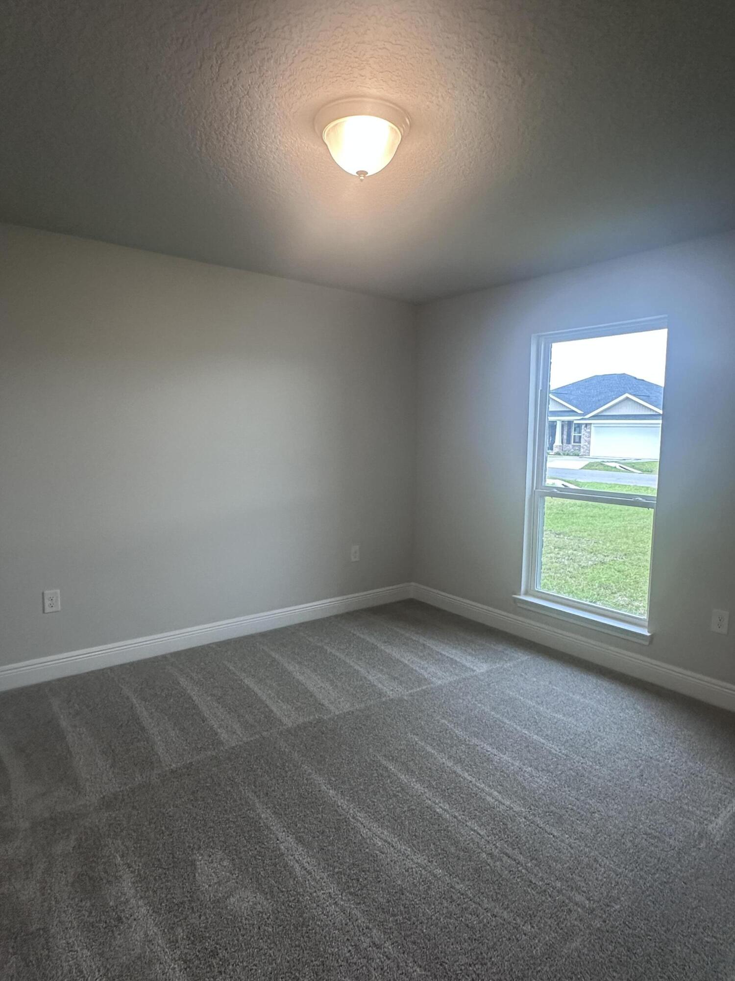 6115 Buckshot Drive Crestview, FL 32539 - Photo 9 of 29 an empty room with a window