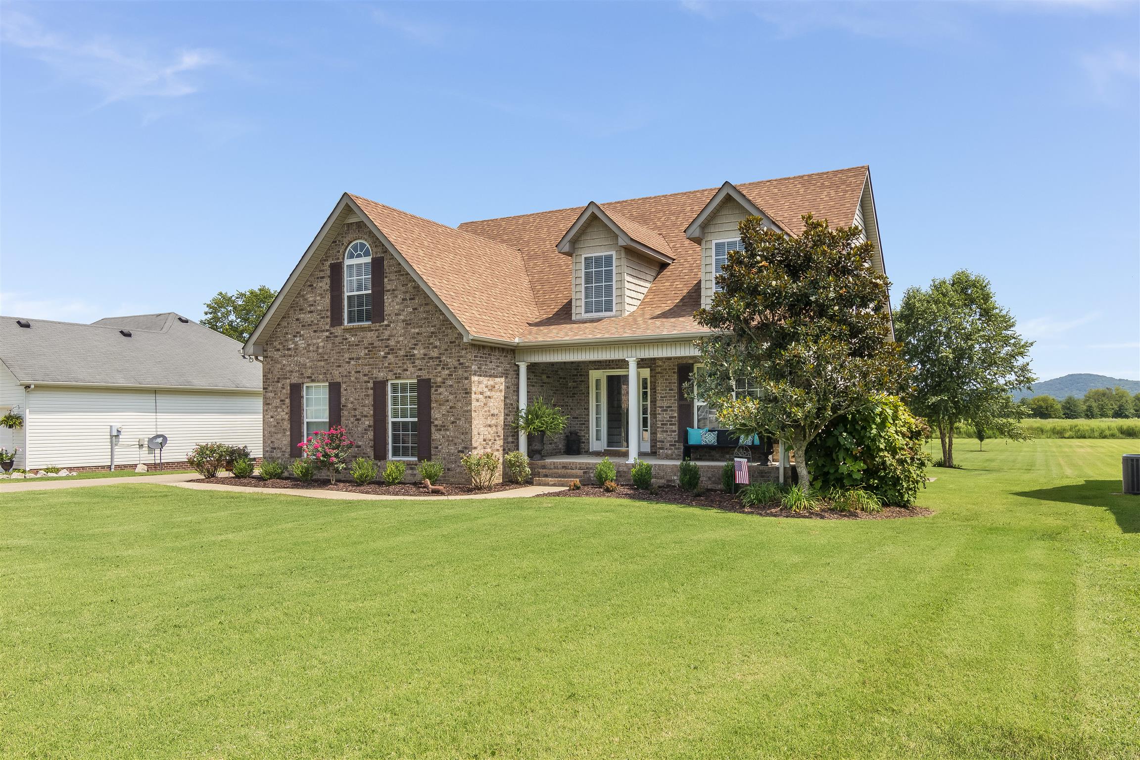 14136 Mt Pleasant Road Rockvale, TN 37153 - Photo 1 of 21 a front view of a house with a yard patio and fire pit