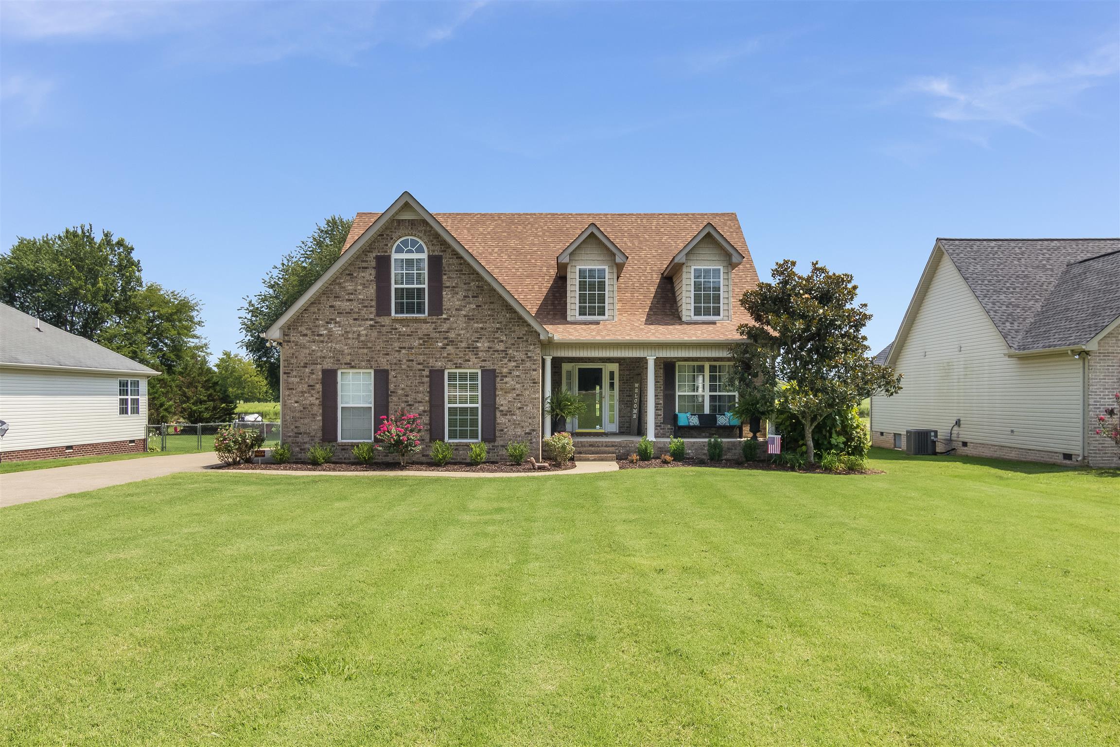 14136 Mt Pleasant Road Rockvale, TN 37153 - Photo 21 of 21 a front view of a house with a garden and trees
