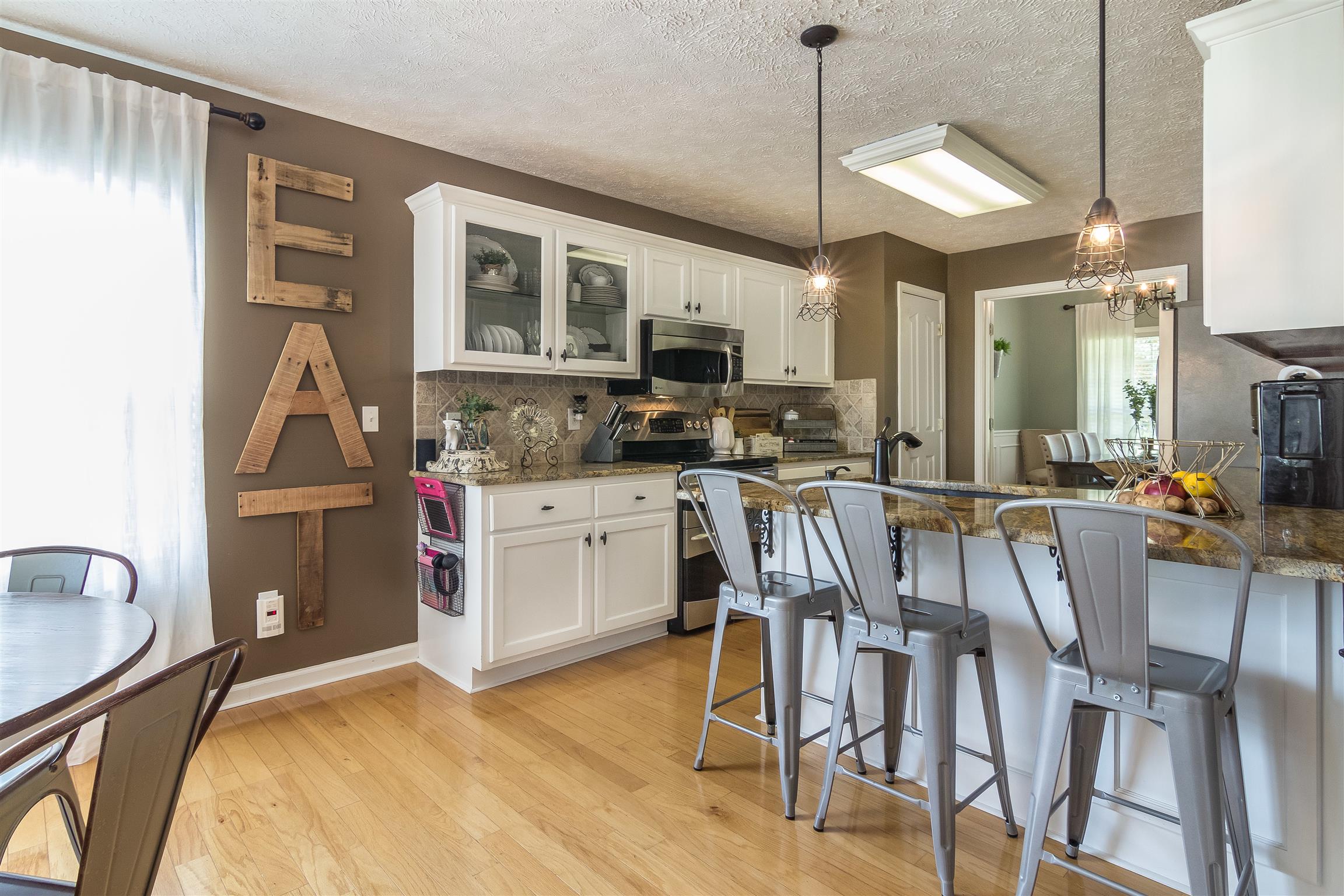 14136 Mt Pleasant Road Rockvale, TN 37153 - Photo 5 of 21 a kitchen that has a table chairs in it and wooden floors
