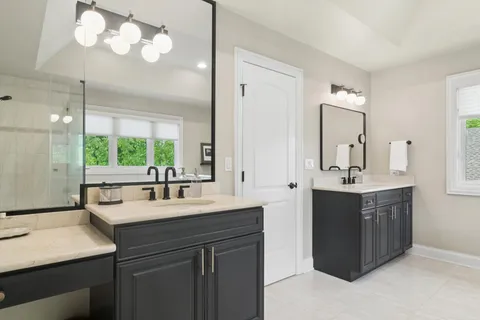 a bathroom with a sink double vanity and a mirror