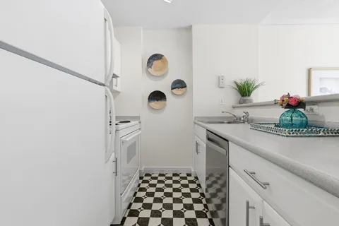 a kitchen with a sink a refrigerator and a stove