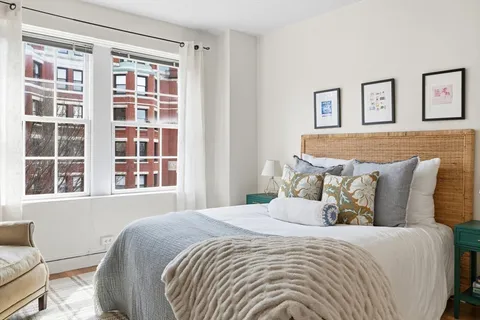 a bedroom with a large bed and a window