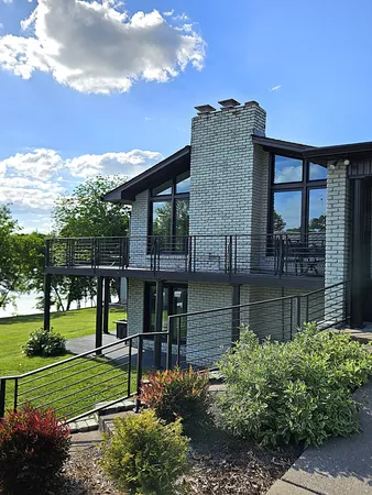 a view of a house with a yard and balcony