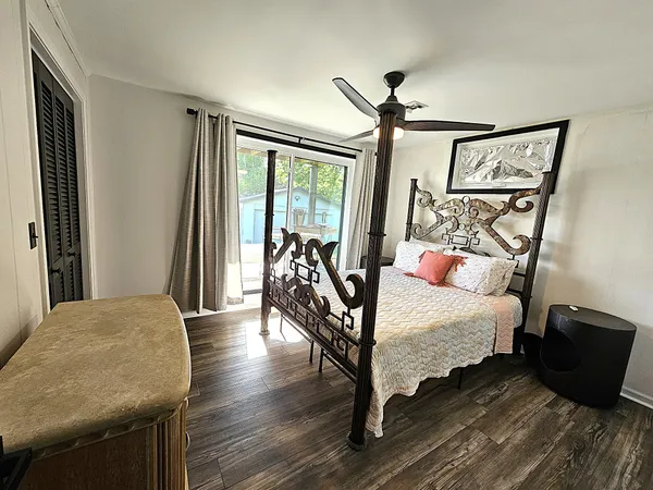 a bedroom with furniture and wooden floor