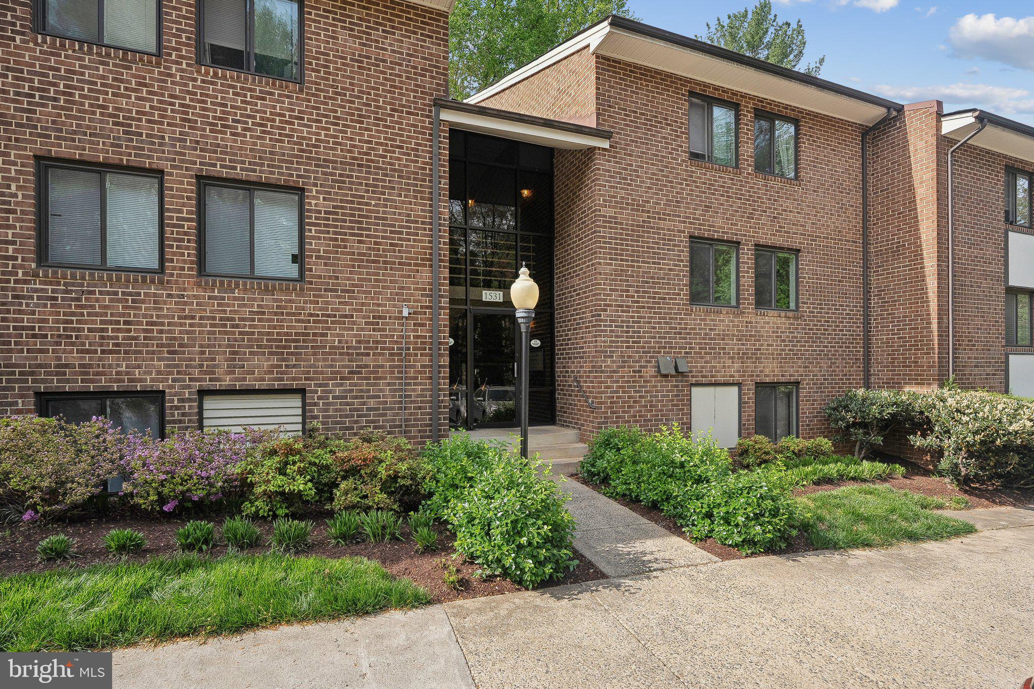 1531 Northgate Square, Unit 12B Reston, VA 20190 - Photo 1 of 34 a front view of a house with garden