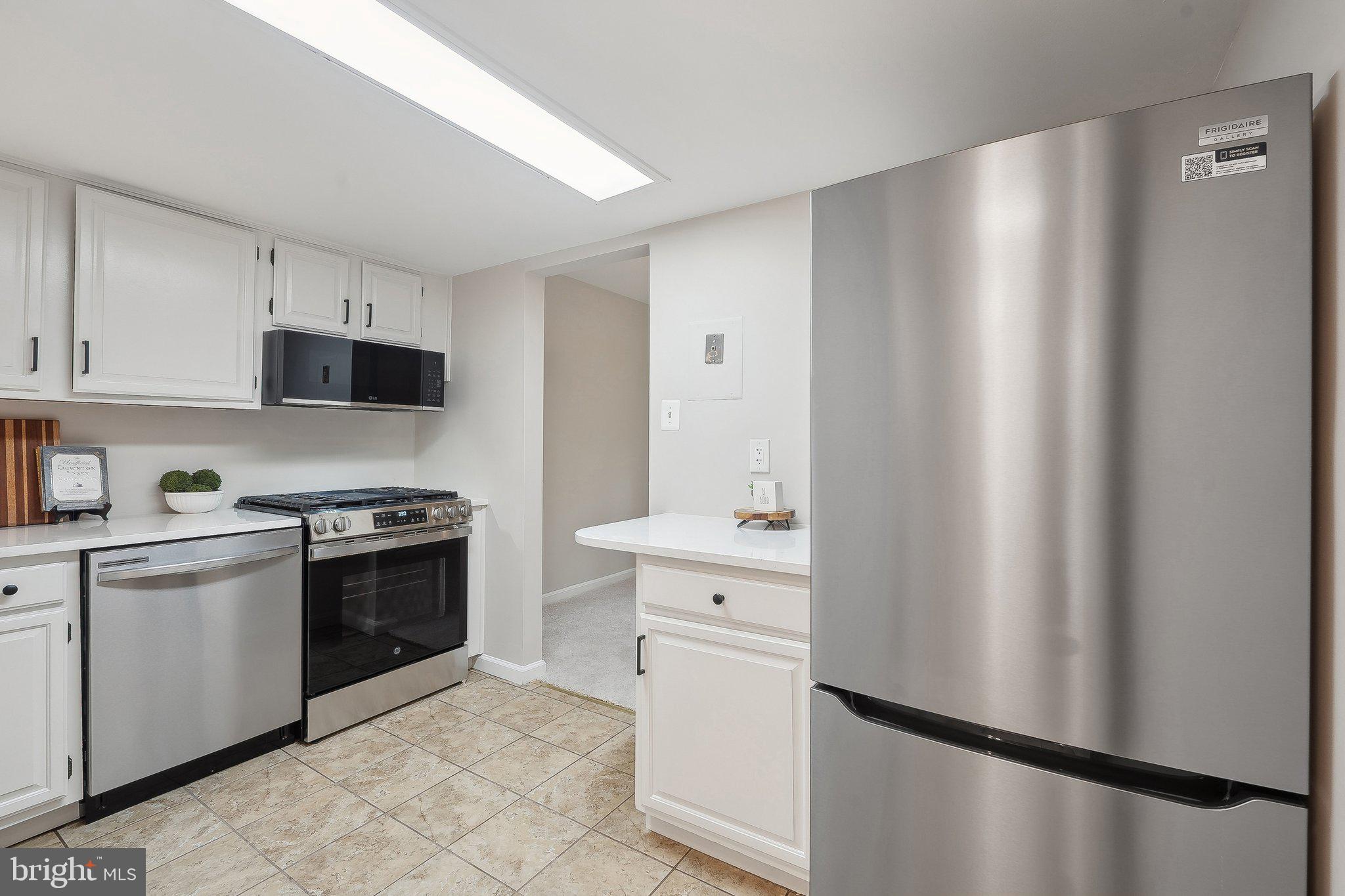 1531 Northgate Square, Unit 12B Reston, VA 20190 - Photo 15 of 34 a kitchen with stainless steel appliances a refrigerator sink and cabinets
