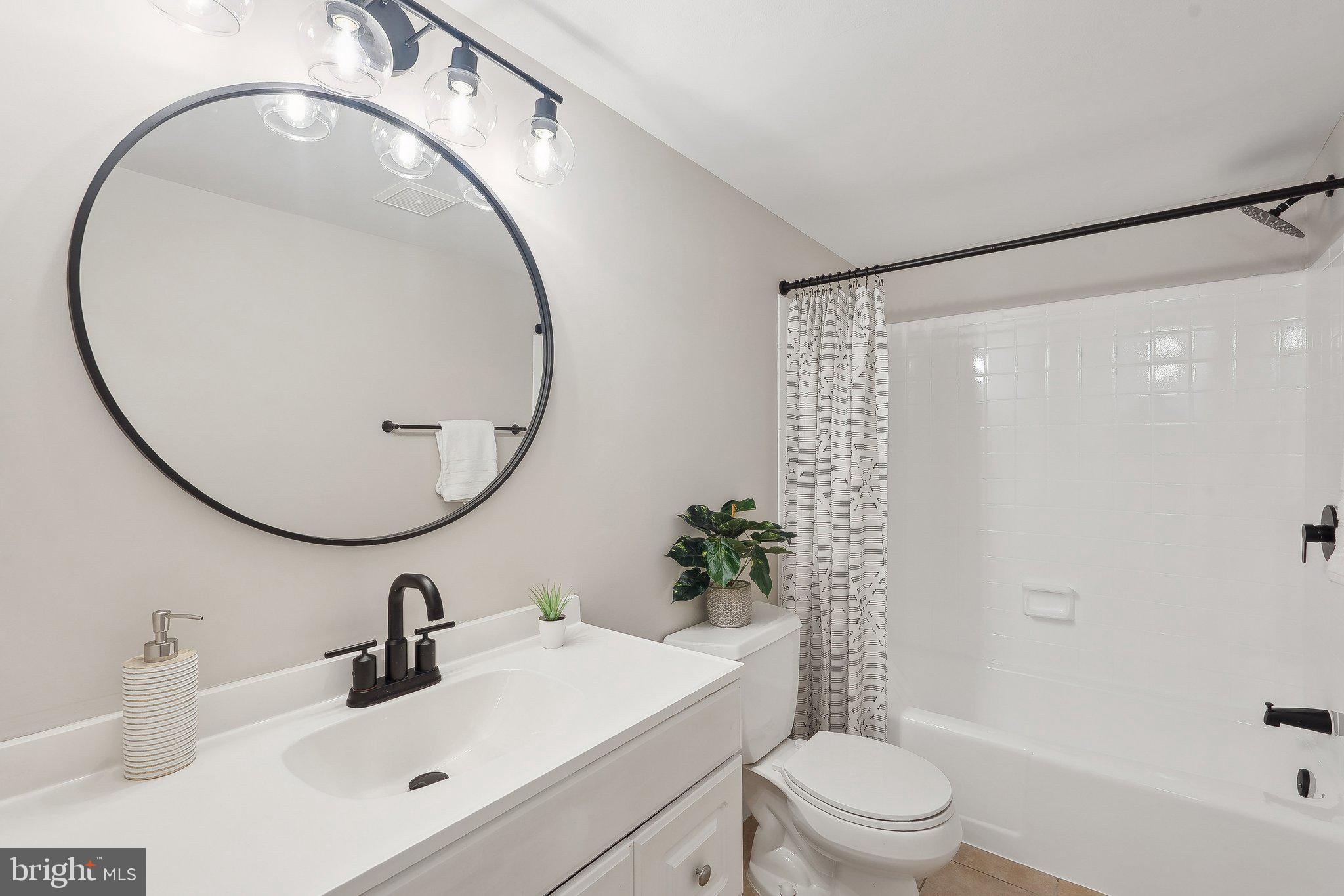 1531 Northgate Square, Unit 12B Reston, VA 20190 - Photo 24 of 34 a bathroom with a sink a toilet and a mirror