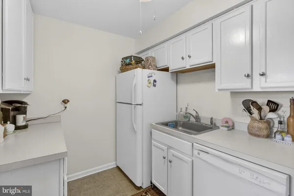 a kitchen with refrigerator and cabinets