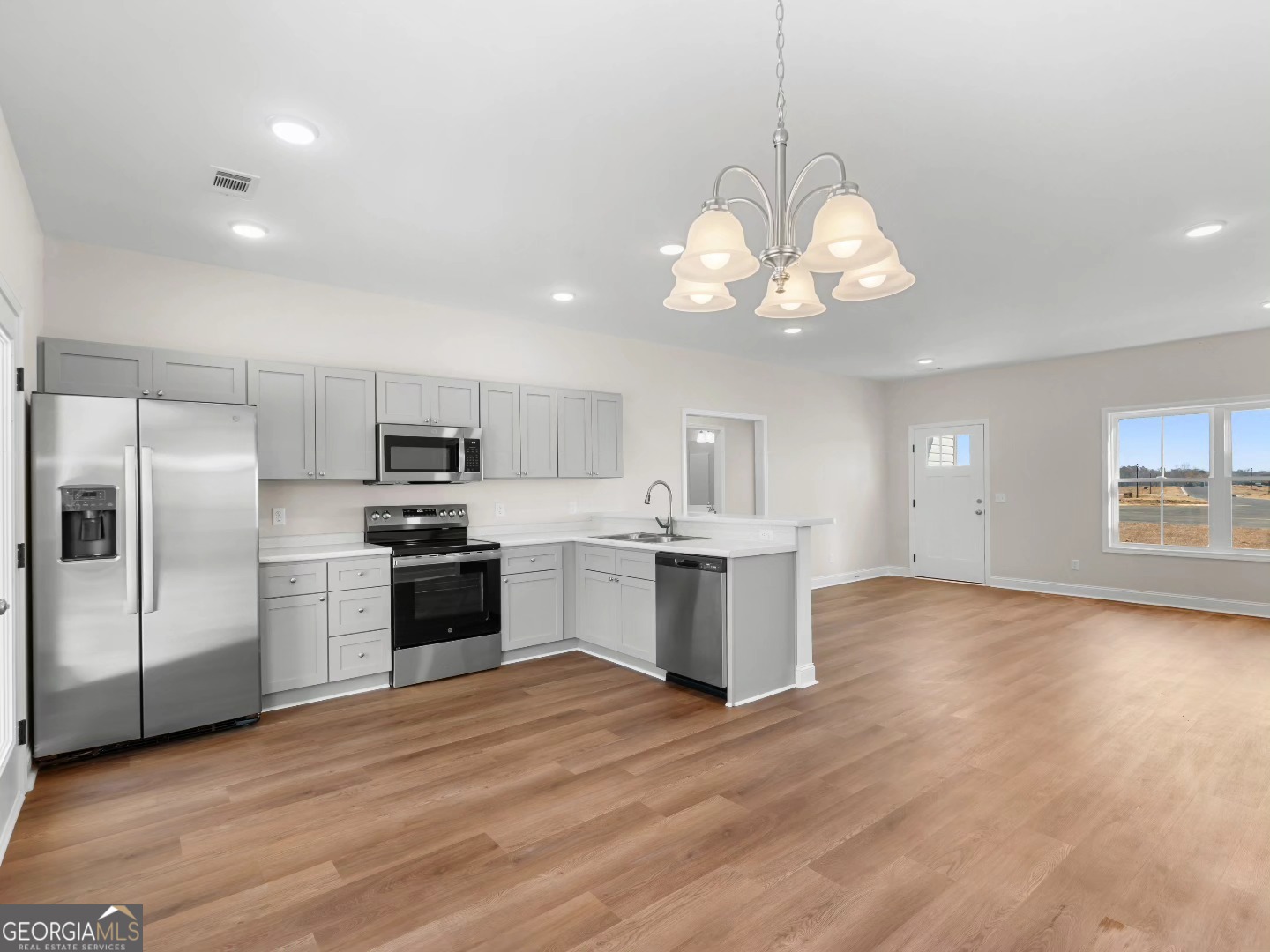 2075 Old Register Road Statesboro, GA 30458 - Photo 9 of 11 a large kitchen with a center island stainless steel appliances cabinets and a window