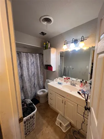 a bedroom with furniture and a flat screen tv