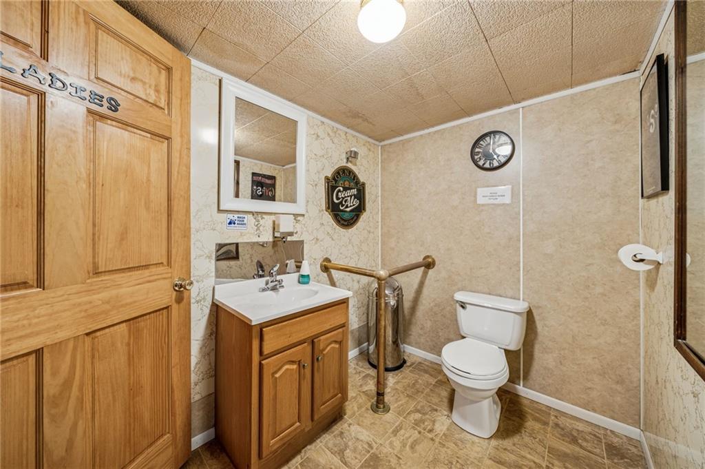 608 North Chestnut Street Derry, PA 15627 - Photo 17 of 50 a bathroom with a toilet sink vanity and mirror