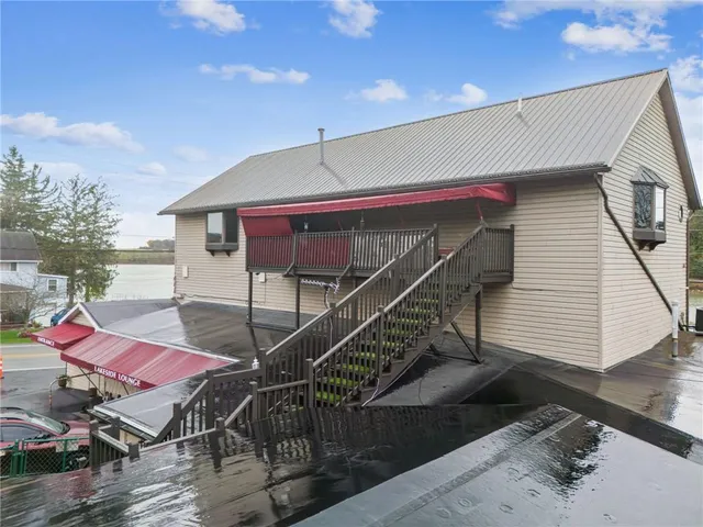 a view of a house with a patio and a yard