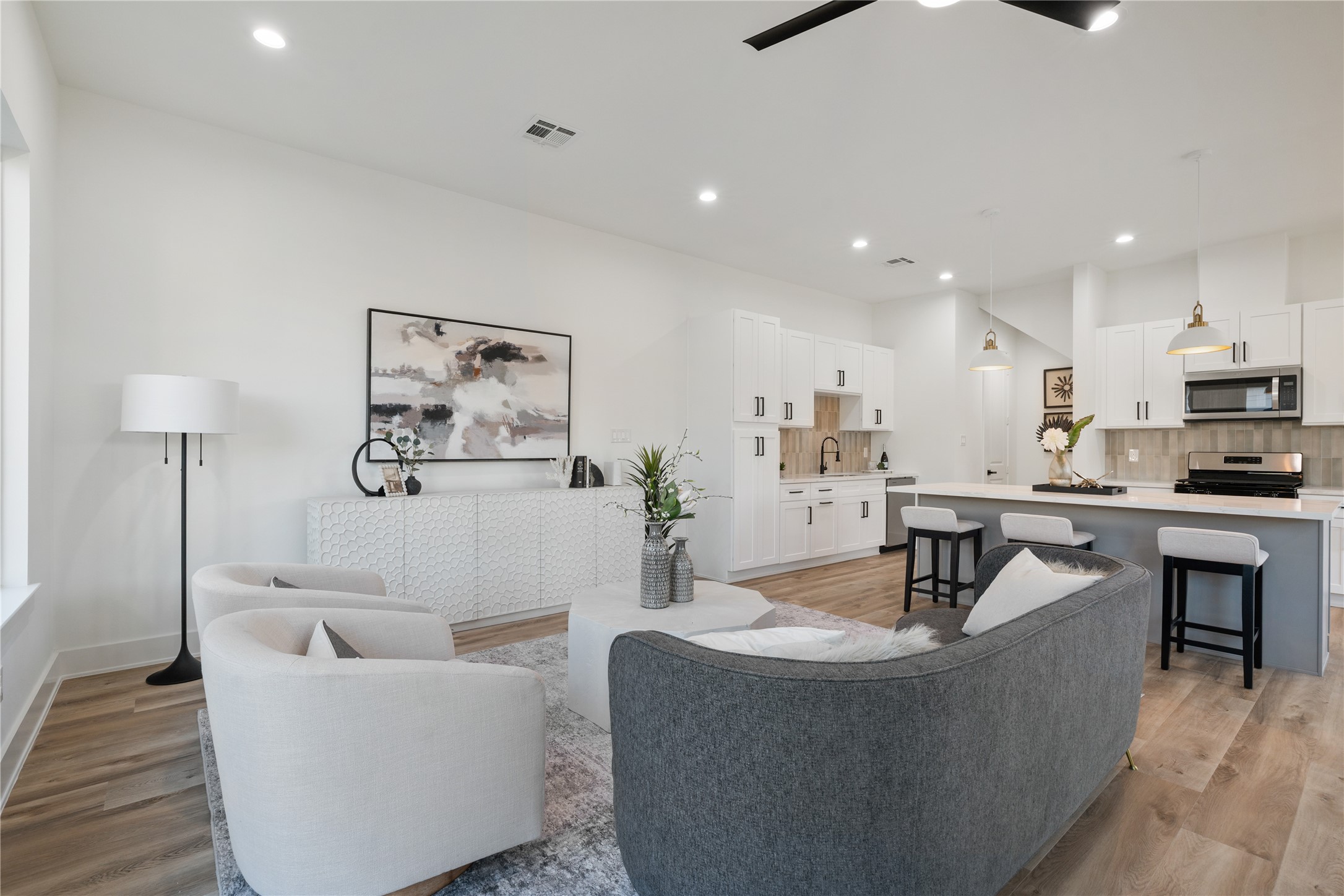 9003 Comal Street Houston, TX 77051 - Photo 14 of 36 The kitchen and living areas flow seamlessly, allowing easy interaction while maintaining distinct spaces for each function. This thoughtful layout balances openness with defined zones, perfect for both everyday life and entertaining. It’s a design that maximizes both connectivity and comfort.