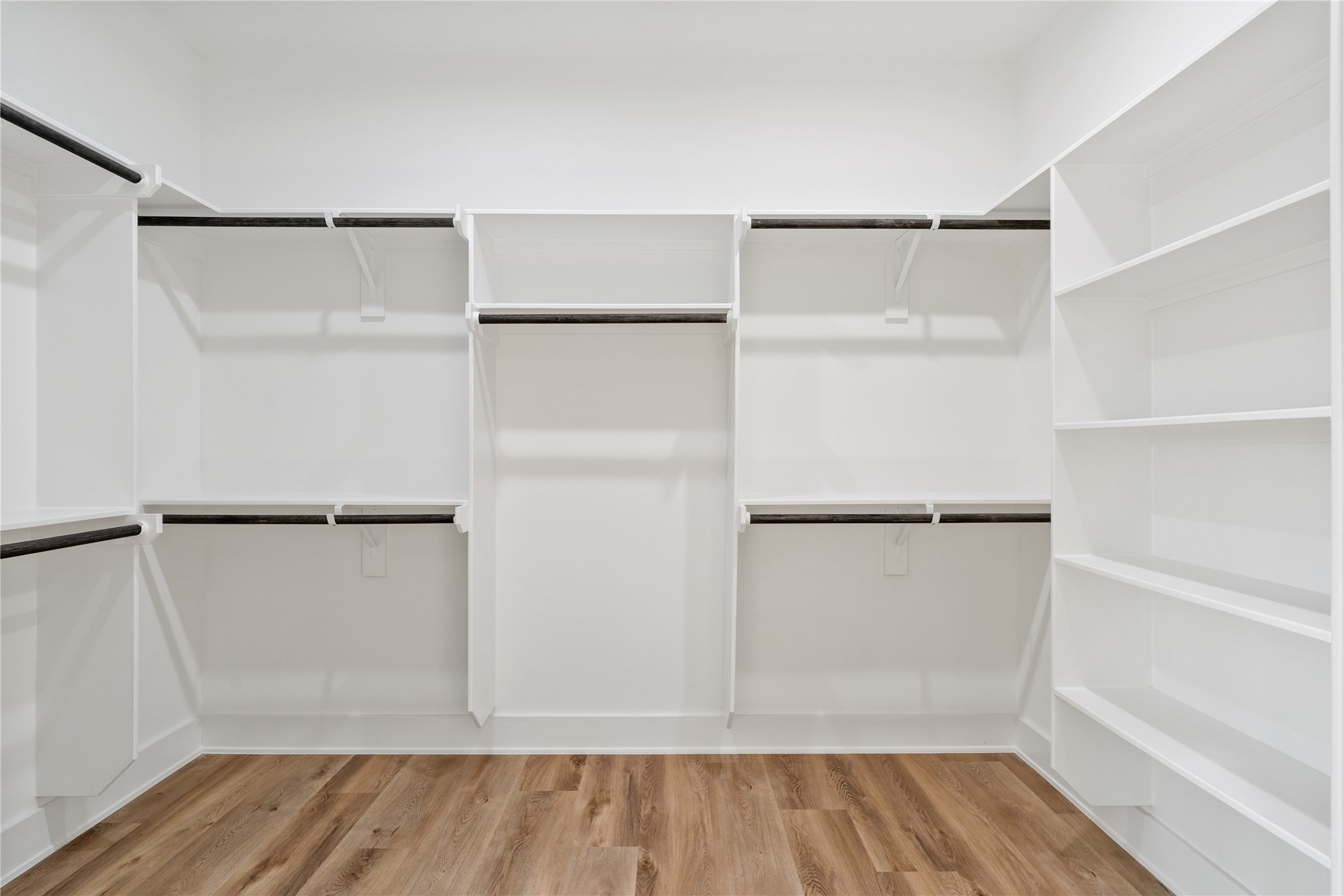 9003 Comal Street Houston, TX 77051 - Photo 28 of 36 The primary suite includes an oversized walk-in closet, providing ample space for clothing, shoes, and accessories. Its generous layout makes organization effortless while maintaining a sense of luxury. This thoughtfully designed space adds both functionality and elegance to the suite.