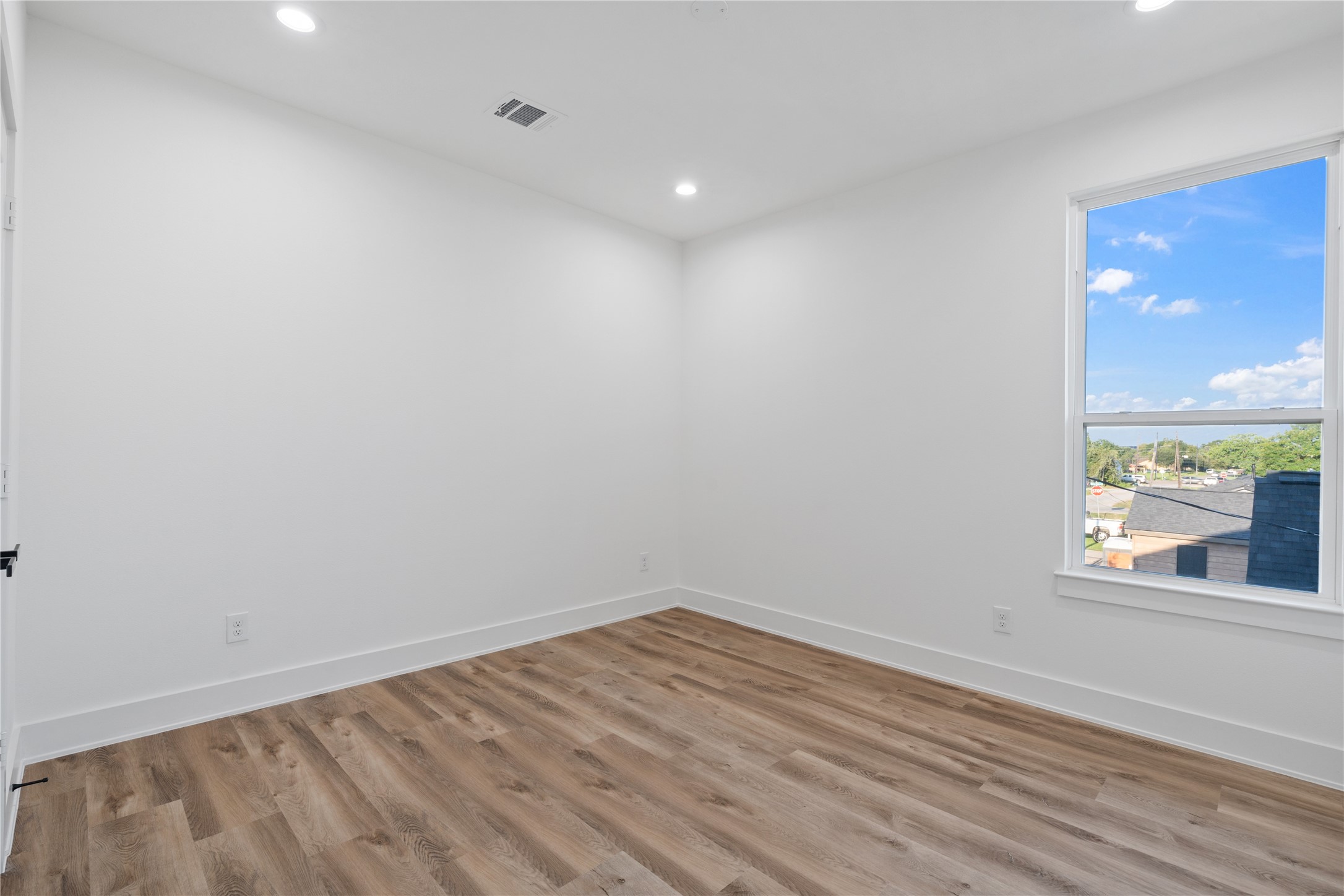 9003 Comal Street Houston, TX 77051 - Photo 29 of 36 The primary bedroom is generously sized, offering plenty of room for relaxation and personal retreat. Its spacious layout enhances comfort and allows for versatile furniture arrangements. This airy, open design creates a serene and inviting atmosphere.