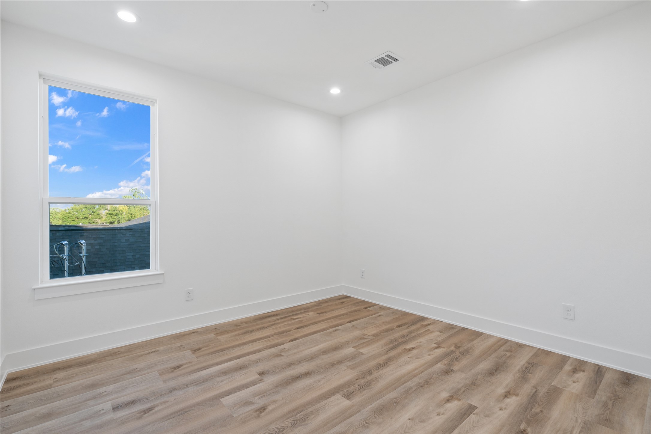 9003 Comal Street Houston, TX 77051 - Photo 31 of 36 Durable LVP flooring flows seamlessly throughout the home, including all bedrooms, creating a cohesive and modern look. It’s easy to maintain while providing warmth and elegance underfoot. This choice enhances the home’s open, airy feel and complements its light, airy design.