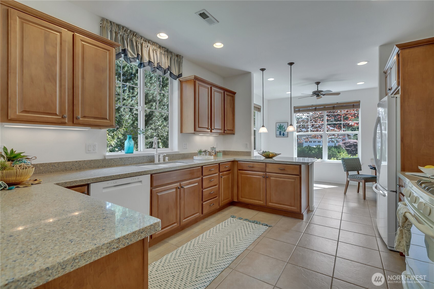 4961 Spokane Street Northeast Lacey, WA 98516 - Photo 7 of 38 a kitchen with a sink a counter top space and stainless steel appliances
